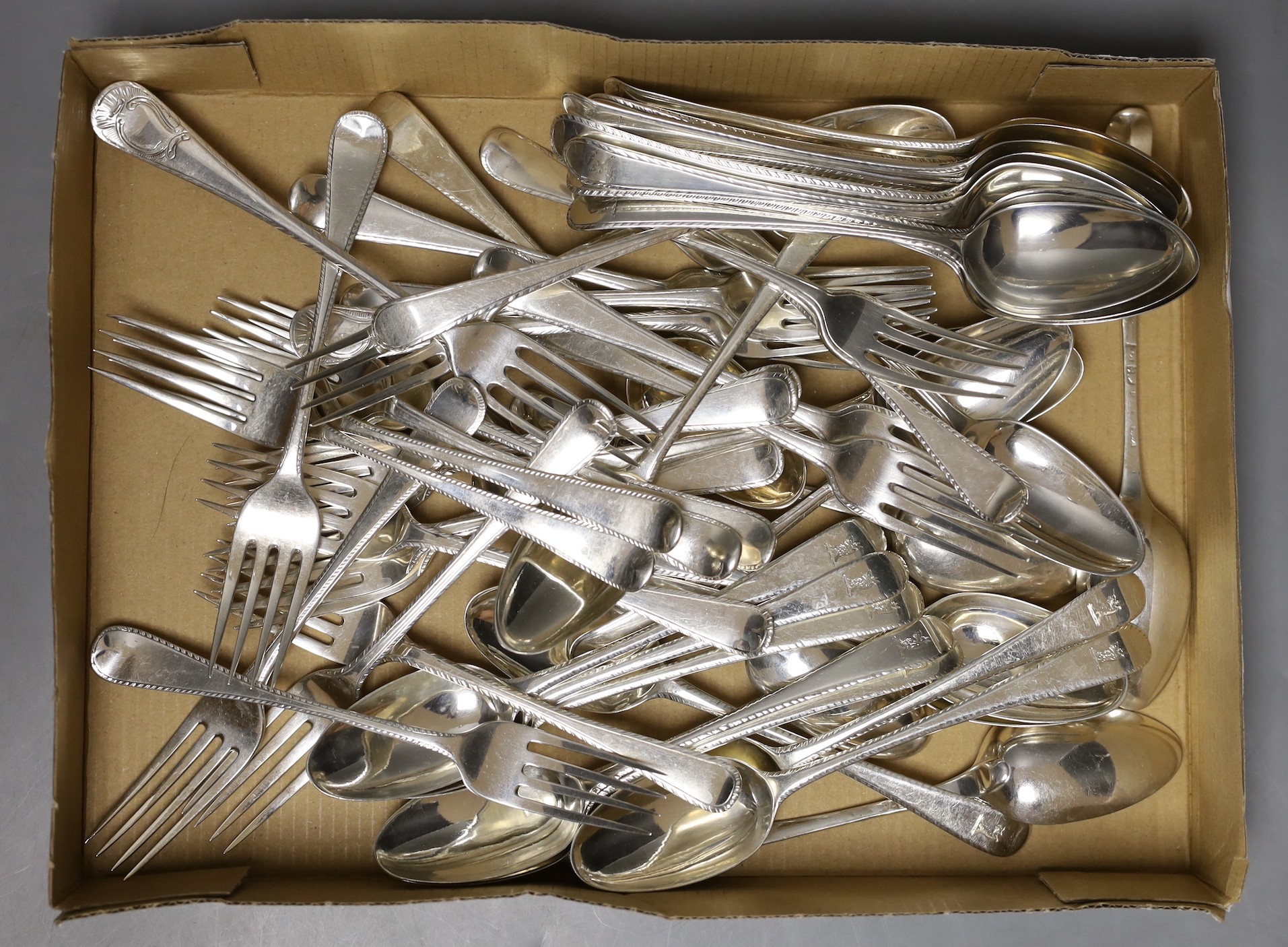 A matched harlequin set of twenty three late 18th/early 19th century silver Old English pattern feather edge dessert forks and thirty two dessert spoons, various dates and makers